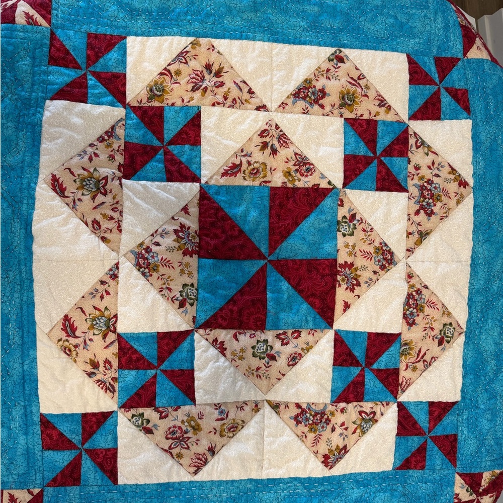 Elegant Floral Patchwork Quilt with Blue and Red Highlights